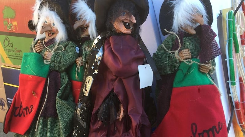 Befana figures clutch stockings with the word ‘coal’ for those who have been naughty.