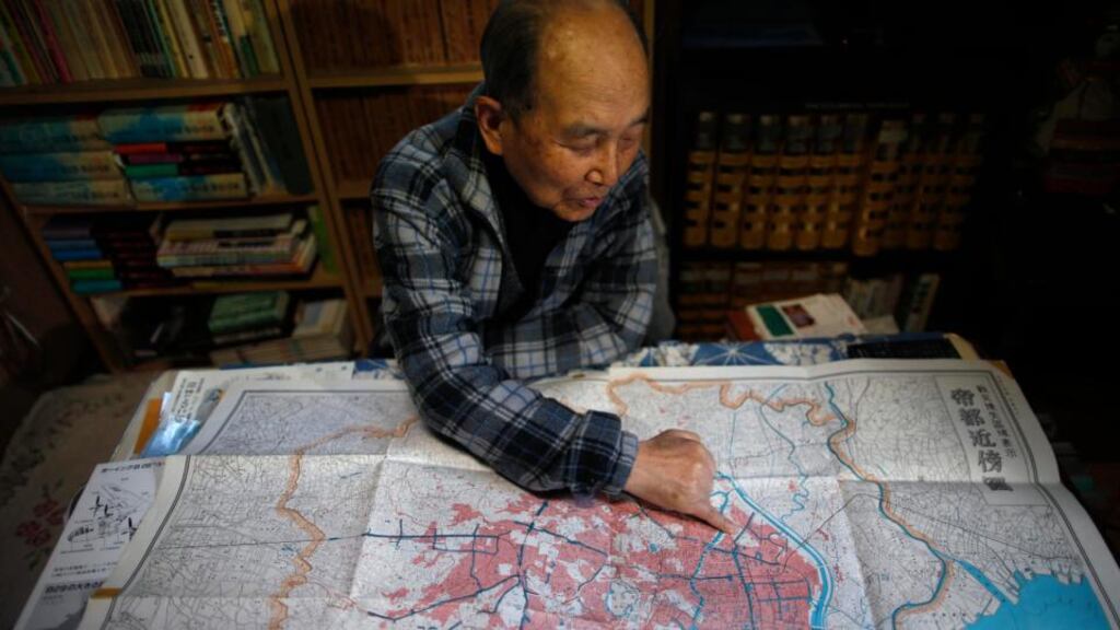 Katsumoto Saotome, (82), a survivor of Great Tokyo Air Raid in 1945, points to a map showing the burned central Tokyo areas in red after the bombing. “They were all individuals,” he says of the 100,000 victims. “They had all been talking to their families hours before they died.” Photograph: Issei Kato/Reuters