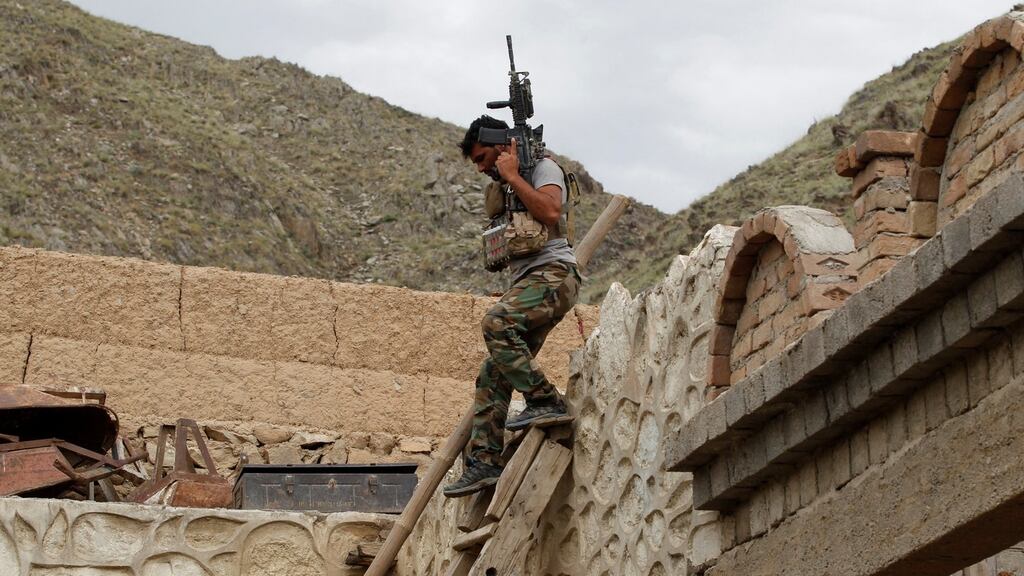 An  Afghan special forces unit member inspects a house which was used by suspected Islamic State militants at the site where a massive US bomb struck, in the Achin district of the eastern province of Nangarhar, earlier this month. Photograph:  Parwiz/Reuters