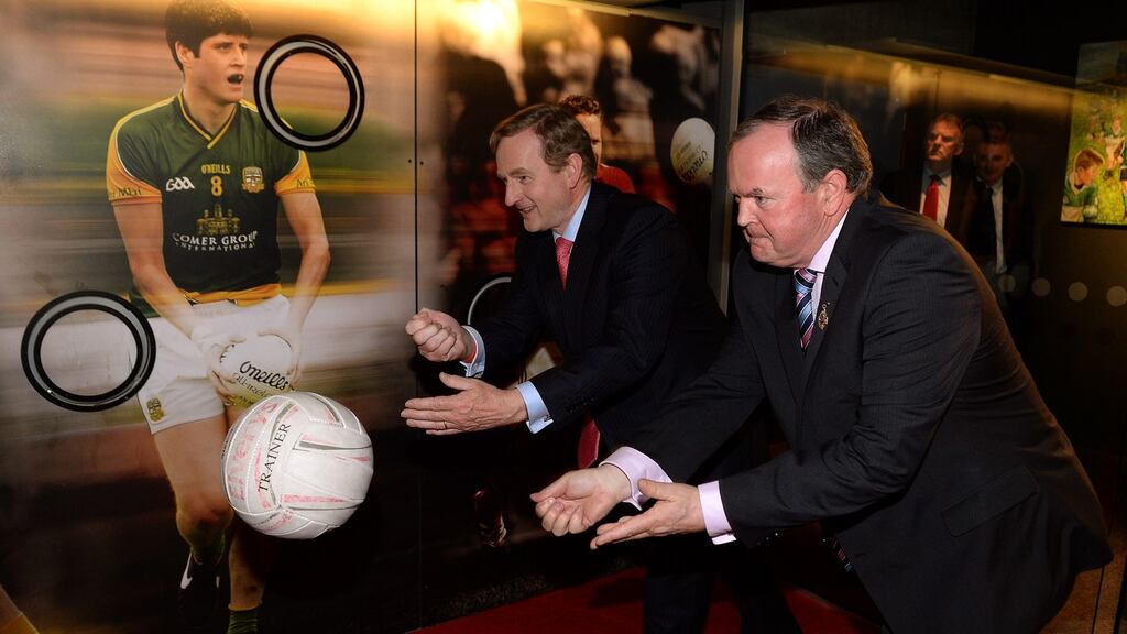 An Taoiseach Enda Kenny trys his skill against GAA President Liam O Neill at the Official opening of the GAA Museum in Croke Park yesterday. Photograph: David Sleator/The Irish Times