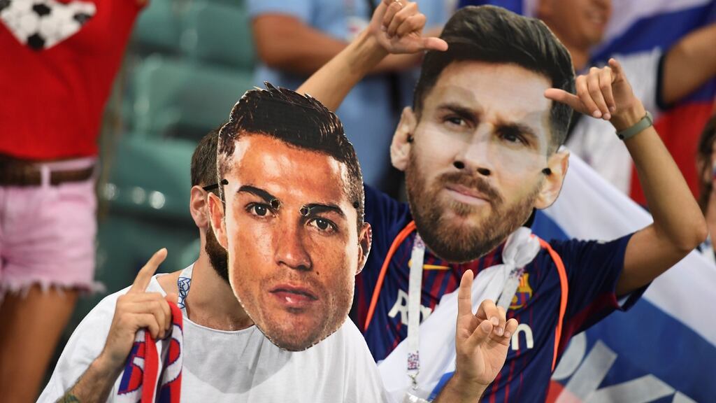 Football fans wearing masks of Cristiano Ronaldo and Lionel Messi at the World Cup in Russia 2018. Photograph: Kirill Kudryavtsev/AFP via Getty Images