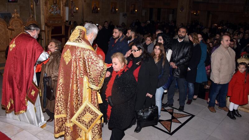 Christians attend prayers during Christmas mass at the Elias Orthodox Church in Aleppo on Christmas Eve. Photograph: George Ourfalian/AFP/Getty Images
