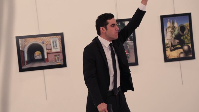 An unnamed gunman gestures after shooting the Russian ambassador to Turkey, Andrei Karlov, at a gallery in Ankara, Turkey. Photograph: Burhan Ozbilici/AP Photo
