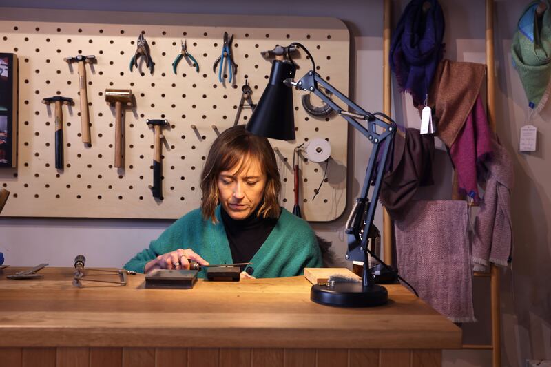 Laura Caffrey makes jewellry at the Irish Design Shop. Photograph: Dara Mac Dónaill