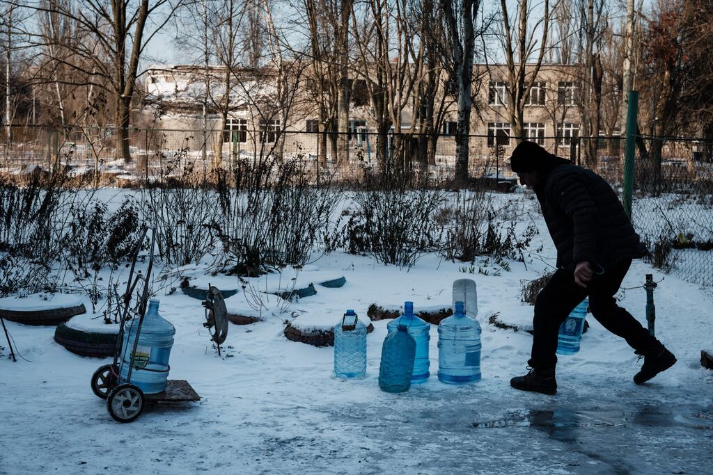 Andrej (51), moves water containers after fetching them at a water point in the frontline city of Avdiivka . Photograph: Yasuyoshi Chiba/AFP via Getty Images