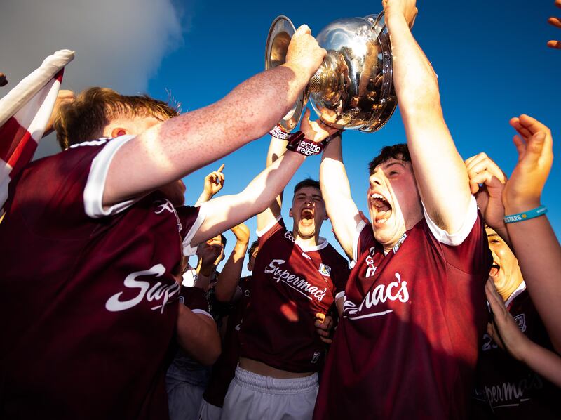 Galway players celebrate with the cup after their win over Mayo in the
Electric Ireland All-Ireland minor final at Dr Hyde Park. Photograph: Evan Logan /Inpho