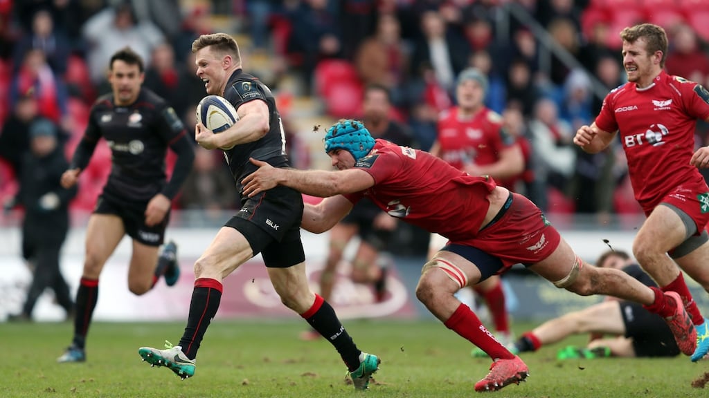 Saracens’ Chris Ashton beats the tackle of Scarlets’ Tadhg Beirne to go on and score their third try against the Scarlets. Photograph: David Davies/PA Wire.