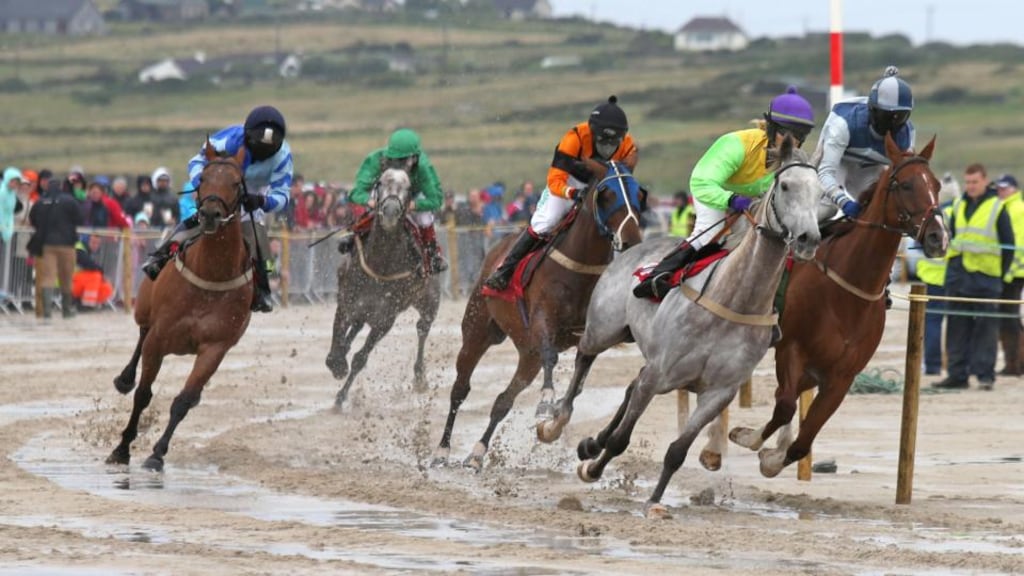 Horses and jockeys pounding the sand at the Omey races in Connemara on Sunday. Photograph: Joe O’Shaughnessy