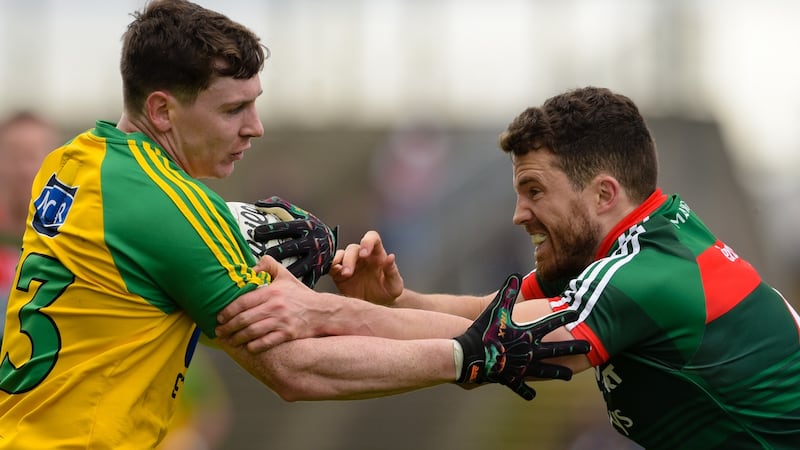 Donegal’s Jamie Brennan is tackled by Mayo’s Chris Barrett. Photograph: Tom Beary/Inpho