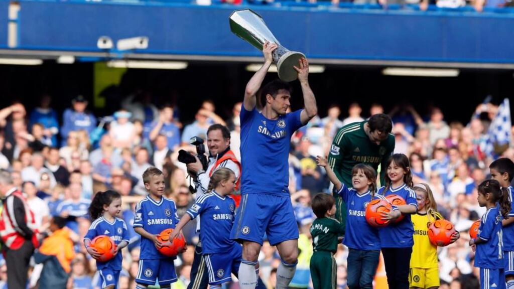 Chelsea’s Frank Lampard holds the Europa League trophy aloft at Stamford Bridge. Photograph: Stefan Wermuth/Reuters