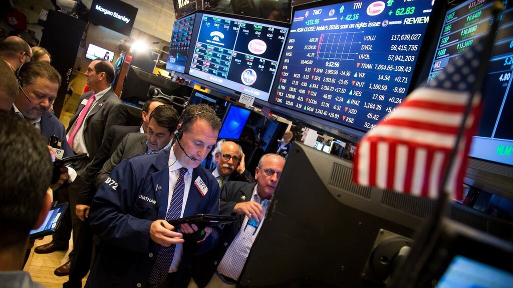 Traders on the floor of the New York Stock Exchange: US stocks fell with the dollar after American employers added the fewest jobs in almost six years in May, bolstering the case for the Federal Reserve to leave interests rates lower for longer. Photograph: Michael Nagle/Bloomberg