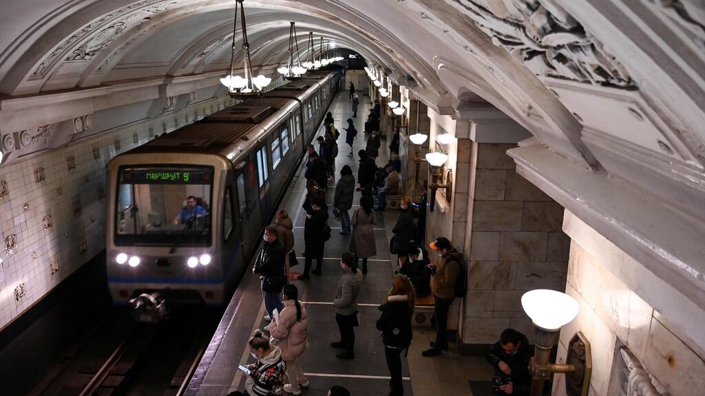 People wearing masks in a metro station in Moscow. Russia confirmed a new record of daily Covid-19 cases (20,582) on Friday. Photograph: Getty