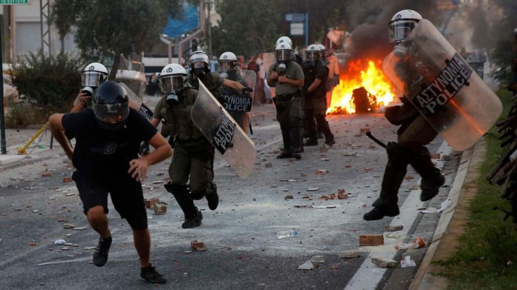 A protester is chased by police during clashes between police and angry anti-fascist protesters following the killing of 35-year-old anti-racism rapper Pavlos Fissas in Athens last week by a man who sympathized with the far-right Golden Dawn group. Photograph: Yannis Behrakis/Reuters