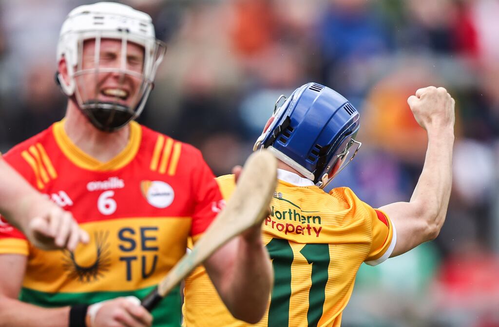 Antrim's James McNaughton after scoring his side's second goal against Carlow in the Leinster senior hurling championship at Corrigan Park, Antrim, with a dejected Kevin McDonald. Photograph: Tom Maher/Inpho