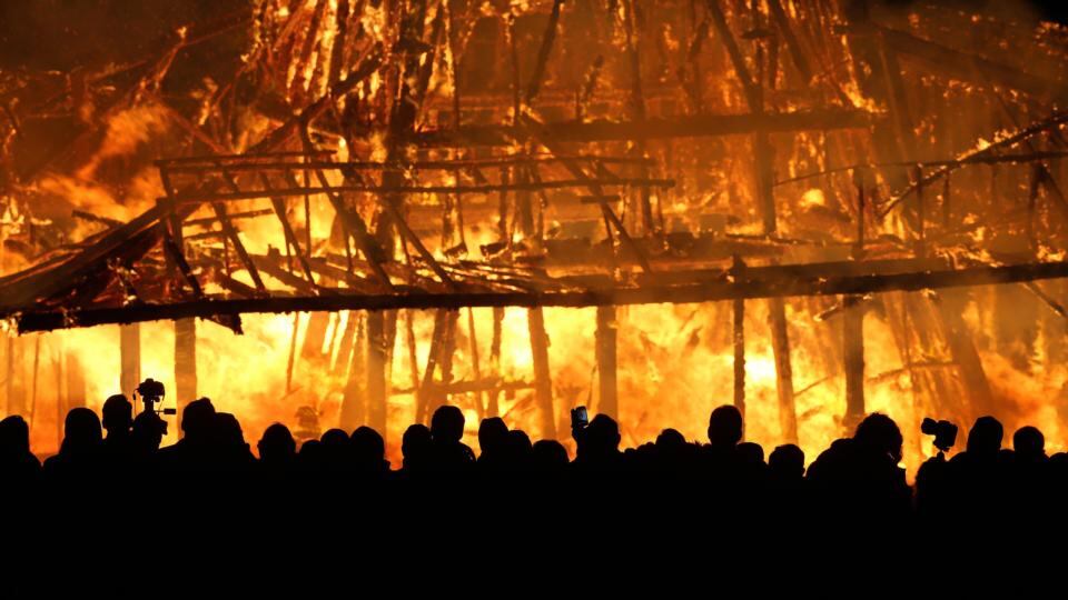 The crowd of thousands watches the inferno take hold. Photograph: Niall Carson/PA Wire