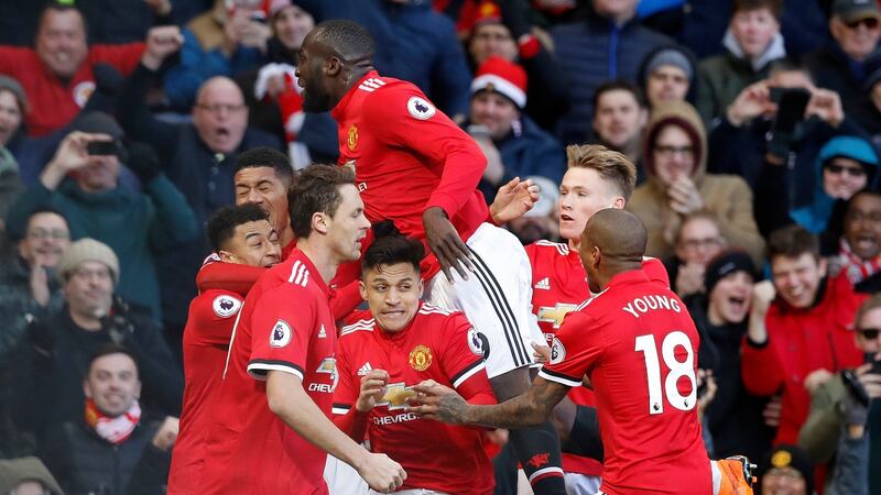 Romelu Lukaku celebrates with his United teammates after Lingard’s goal. Photo: Martin Rickett/PA Wire
