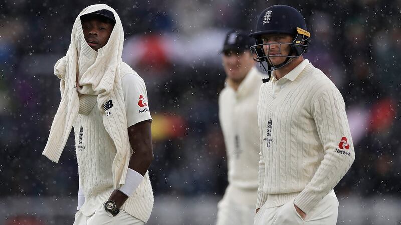 Jofra Archer and Jos Buttler of England leave the ground as rain stops play during day one of the fourth Test against Australia at Old Trafford. Photograph: Ryan Pierse/Getty Images