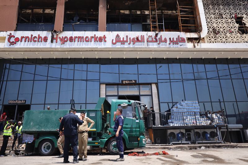 A cleaning operation starts after a fire tore through a newly opened shopping centre overnight in the eastern Iraqi city of Kut. Photograph: AHMAD AL-RUBAYE/AFP via Getty Images