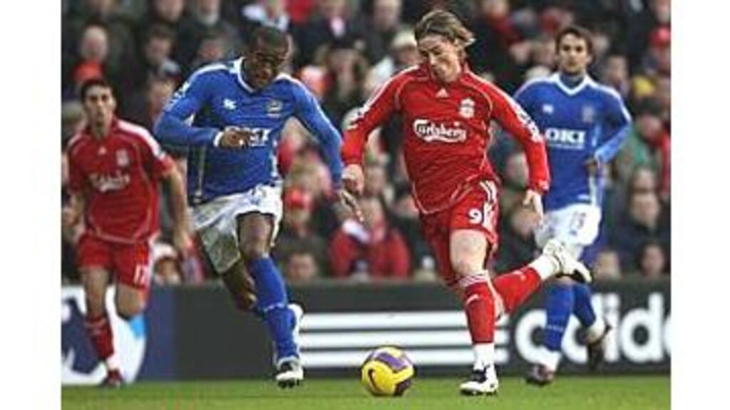 Fernando Torres of Liverpool is pursued by Sylvain Distin of
Portsmouth during their Premier League match at Anfield. Torres
scored two in the 4-1 home win.