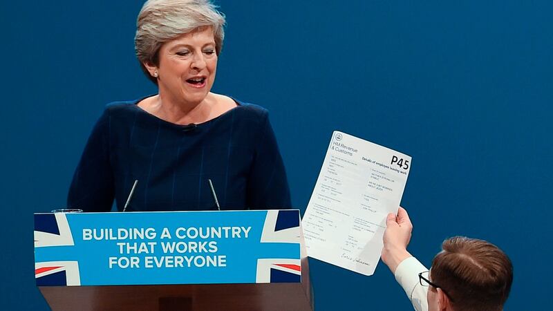 Protester comedian Simon Brodkin (R) gives a piece of paper written as a mock P45 (employee leaving form) to Britain’s prime minister Theresa May (L) as she was delivering her speech on the final day of the Conservative Party annual conference on October 4th. Photograph: Paul Ellis/AFP/Getty Images