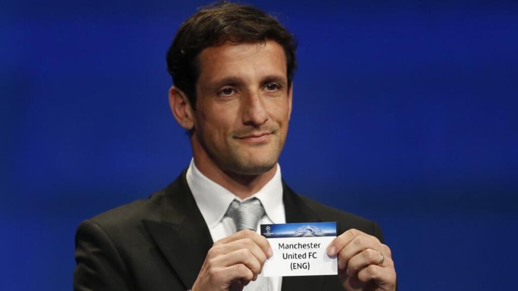 Former Barcelona player Juliano Belletti shows the name of Manchester United football club during the UEFA Champions League Group stage draw ceremony in Monaco. Photo: Valery Hache/Getty Images
