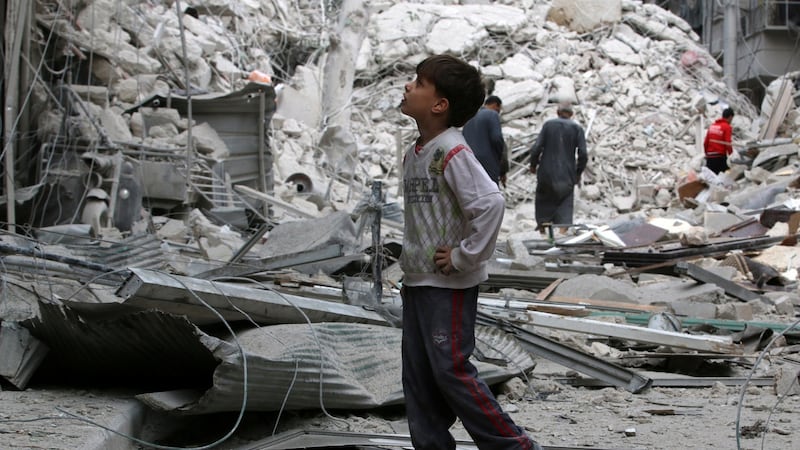 A boy inspects a damaged site after airstrikes on the rebel held Tariq al-Bab neighbourhood of Aleppo on Friday. Photograph: Reuters