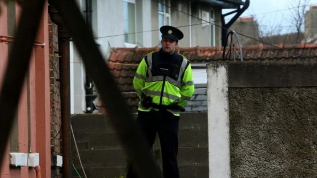 A garda outside the house at Ashdale Gardens in Terenure, Dublin, where Cathal Sweeney was fatally attacked. Photograph: Brian Lawless/PA Wire