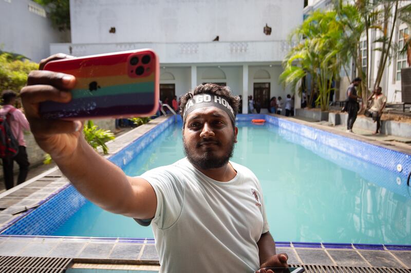 A protester takes a selfie inside the presidential palace in Colombo on Wednesday. Photograph: Abhishek Chinnappa/Getty Images