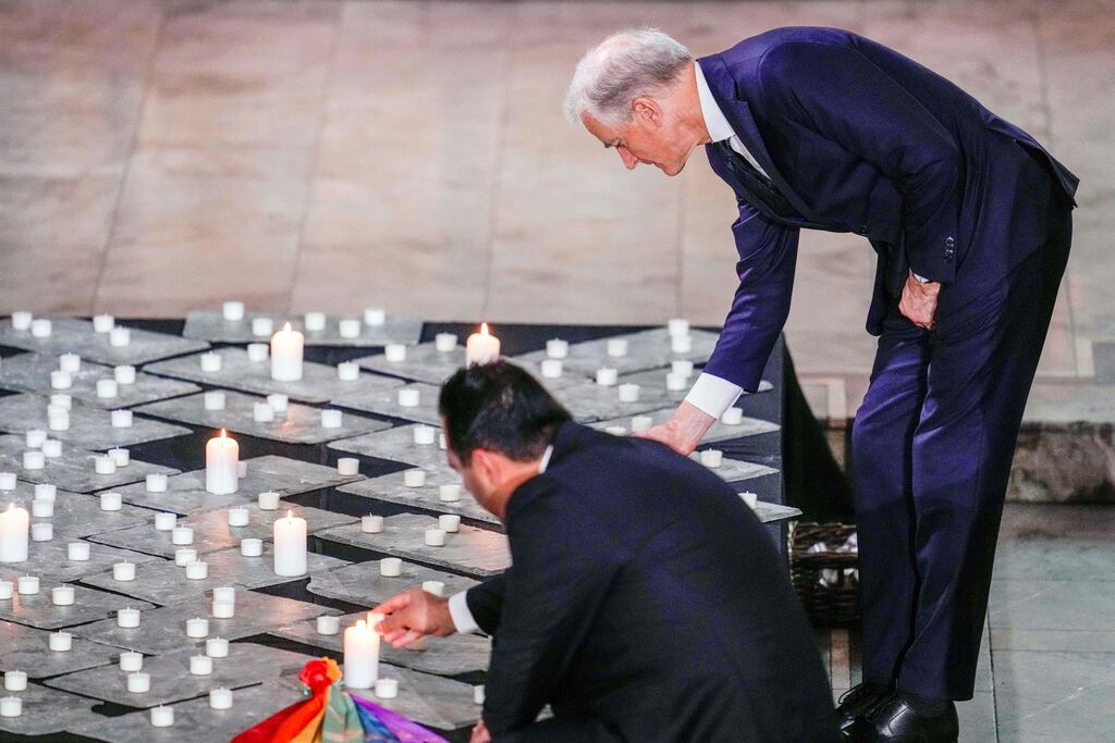 Norway's President of the Storting Masud Gharahkhani and Norway's Prime Minister Jonas Gahr Store light candles during a mourning service in Oslo Cathedral in Oslo on Sunday after a shooting outside pubs and nightclubs in central Oslo killing two people and injuring 21.. Photograph: Javad Parsa /AFP via Getty Images
