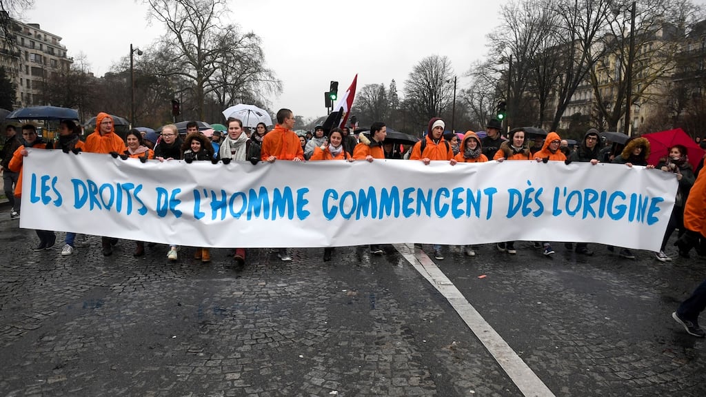 Campaigners hold banners reading “Human rights begin from the origin” in Paris during a demonstration against abortion and medically assisted procreation in January. Photograph: Eric Feferberg/AFP/Getty Images