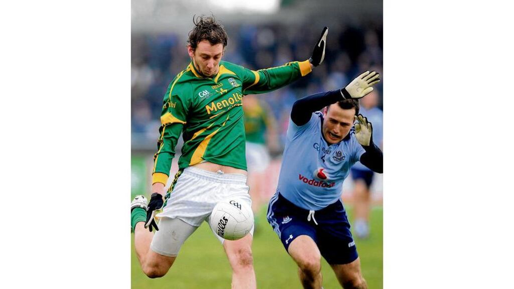 Meath forward Jamie Queeney looks to get his shot away as Dublin's Conor McCormack moves in to block him during yesterday's O'Byrne Cup quarter-final at Parnell Park. Colin Daly scores the equalising point for Dublin in extra-time to earn his side a replay, likely to be Pairc Tailteann, Navan, on Wednesday evening.