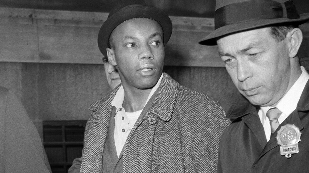 Muhammad Aziz being escorted by detectives after his arrest in New York in 1965. He is one of the men set to be exonerated over the murder of Malcolm X. Photograph: AP