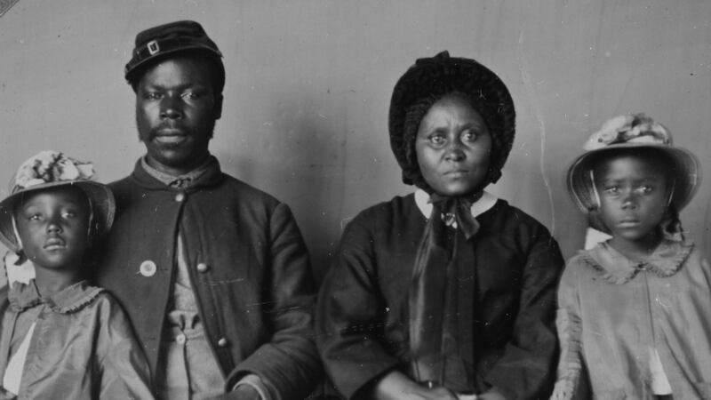 African American soldier in uniform, with his wife  and two daughters. Photograph: Buyenlarge/Getty Images
