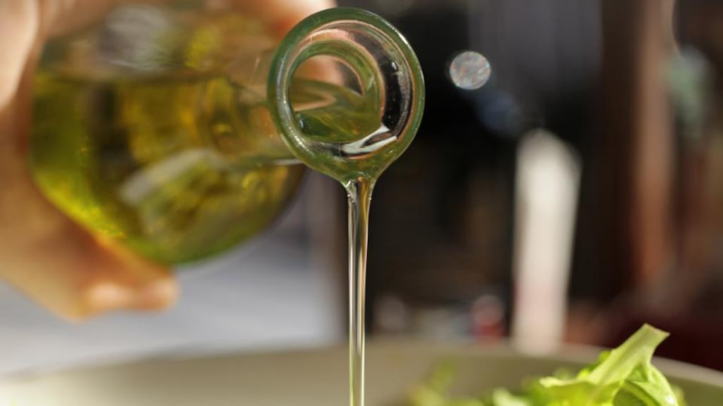 Pouring olive oil on fresh green salads is one way of adding small volumes of high-calorie foods to meals. Photograph: Getty Images
