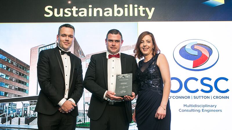 Ciaran O’Hagan, Group Managing Director, Specialist Joinery Group presents the Excellence in Sustainability award to Patrick Field & Patrice McVeigh, O'Connor Sutton Cronin (M&E)