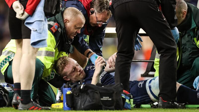 Dan Leavy receives treatment on the pitch after suffering a knee injury in Leinster’s Heineken Champions Cup quarter-final against Ulster at the Aviva Stadium in March 2019. Photograph: Billy Stickland/Inpho