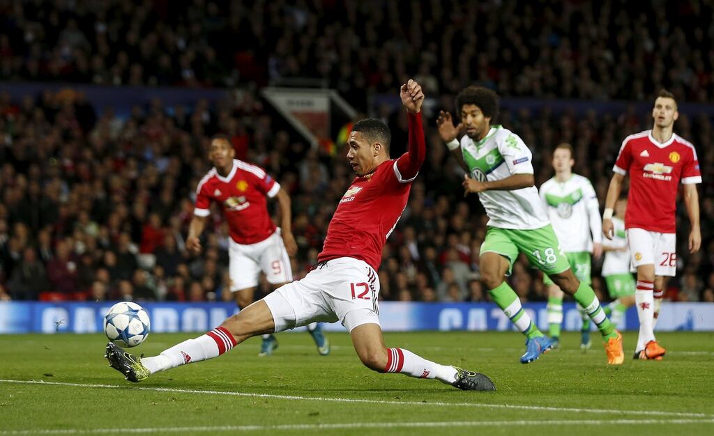 Chris Smalling stretches to steer home Manchester United’s winner against  VfL Wolfsburg at Old Trafford. Photo: Lee Smith/Reuters I