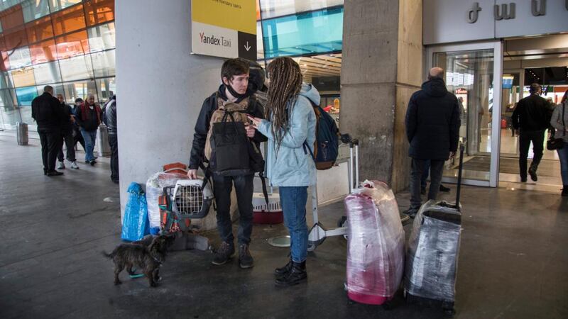 Russian immigrants Bulat Mustafin (24) his girlfriend Viktoria Poymenova (22) and their pets arrive in Yerevan. Photograph: Daro Sulakauri/The New York Times