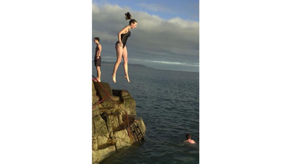 Christmas in a cold climate: a swimmer takes the plunge at the Forty Foot in Dublin for the annual Christmas Day swim.