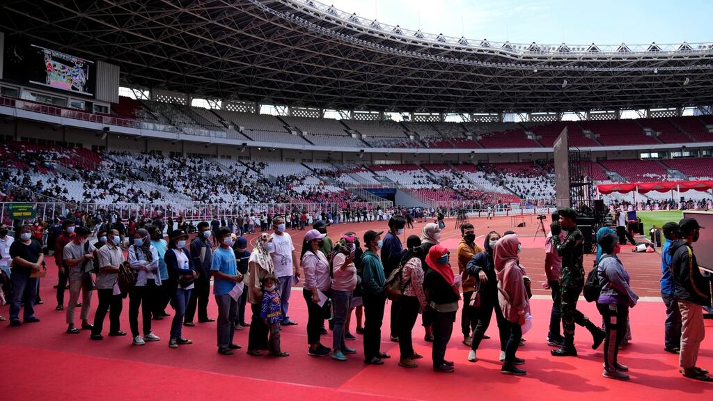 People queue to receive the Sinovac Covid-19 vaccine during a vaccination campaign at Patriot Candrabhaga Stadium in Bekasi on the outskirts of Jakarta, Indonesia, on Thursday. Photograph: AP Photo/Achmad Ibrahim