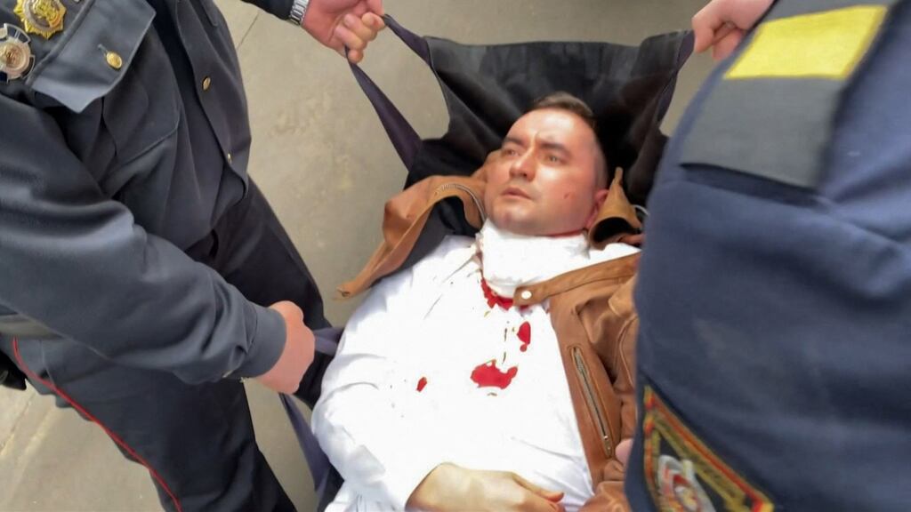 Belarusian law enforcement officers carry Stepan Latypov from a court in Minsk after he stabbed himself in the neck during his trial. Photograph: Radio Free Europe/Radio Liberty/AFP via Getty Images