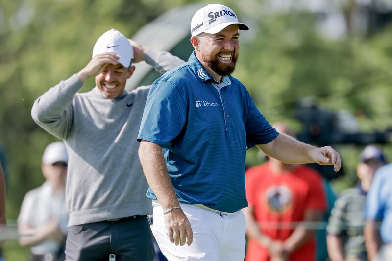 Rory McIlroy (L) of Northern Ireland and Shane Lowry (R) of Ireland laugh on the green of the ninth hole. Photograph: Erik S Lesser/EPA