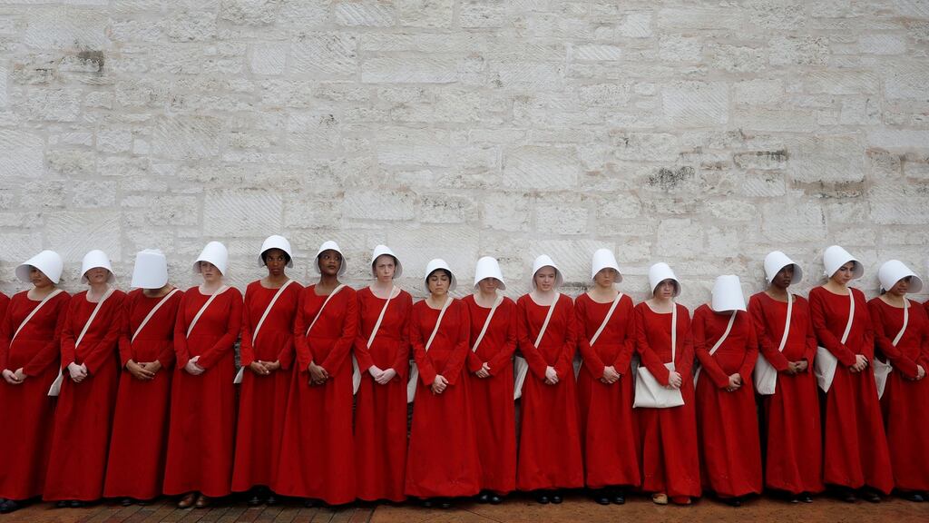 Women dressed as handmaids promoting the Hulu original series The Handmaid’s Tale, stand along a public street during the South by Southwest Music Film Interactive Festival in Austin, Texas, Photograph:  Reuters/Brian Snyder