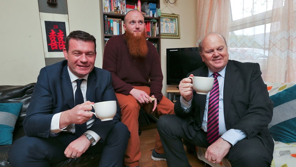 Minister for the Environment Alan Kelly and Minister for Finance Michael Noonan pictured with Eoin Whelan at his apartment in Phibsboro where they met with a couple who have benefitted from tenancy sustainment protocol. Photograph: Colin Keegan, Collins Dublin