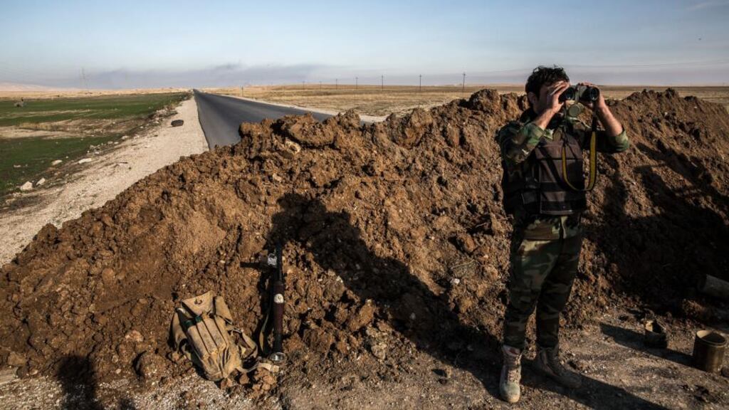 A peshmerga soldier on Highway 47, which links Mosul and Raqqa: Families of Islamic State fighters are believed to be attempting to flee to Mosul in Iraq where IS also holds sway. Photograph: Bryan Denton/The New York Times