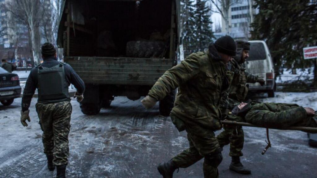 Pro-Russian rebels unload the body of a slain colleague at a hospital in Donetsk, Ukraine yesterday. Photograhp: Brendan Hoffman/The New York Times
