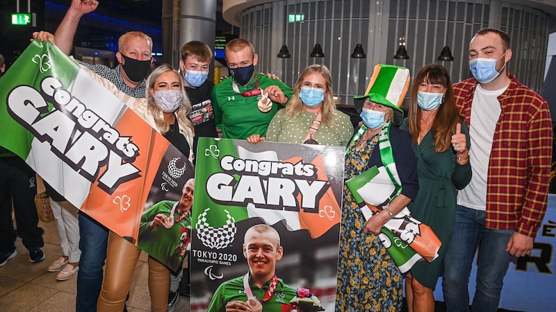 Garry O’Reilly, H5 time trial bronze medallist, with family on his return from the Tokyo 2020 Paralympic Games, at Dublin Airport in Dublin. Photograph: Sportsfile