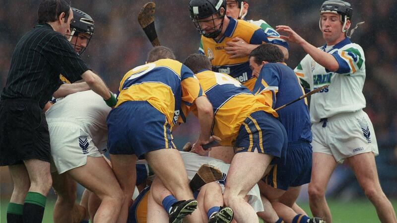 Referee Willie Barrett tries to stop a fight between Waterford and Clare players during the 1998 Munster Hurling Final. Photograph: James Meehan/Inpho