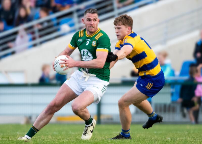 Meath’s Bryan Menton holds off Roscommon’s Pearse Frost. Photograph: Evan Logan/Inpho