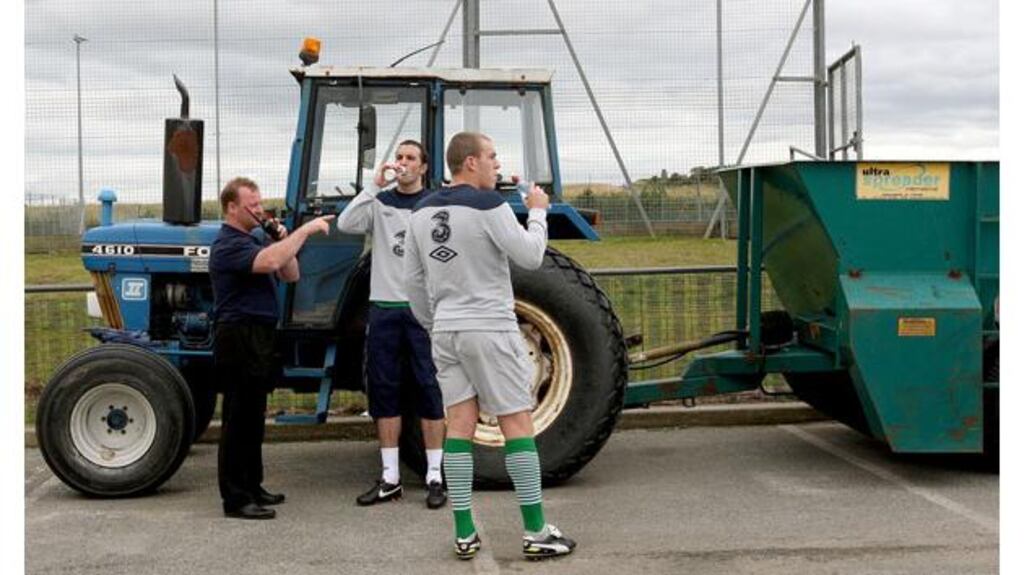 John O'Shea and Richard Dunne get some refreshment during training at Malahide FC's Gannon Park today. - (Photograph: Lorraine O'Sullivan/Inpho)